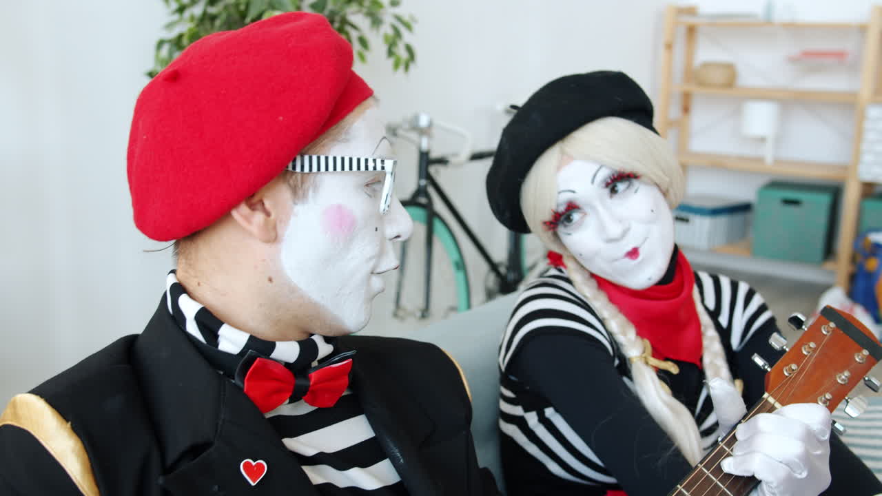 Mime Duo Performing with Acoustic Guitar