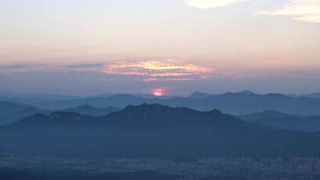 incredible sunset over a silhouetted mountain landscape at golden hour in asia