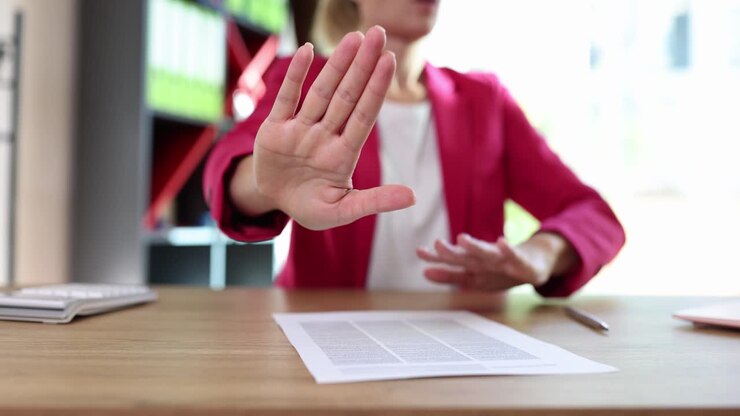 Woman refusing to sign a contract in the office