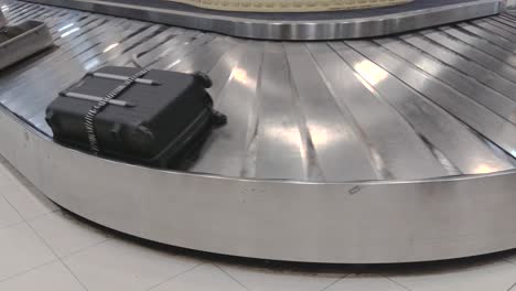 suitcases on the baggage conveyor belt at the airport. close-up of moving valise on the luggage conveyor in the airport. handheld shot