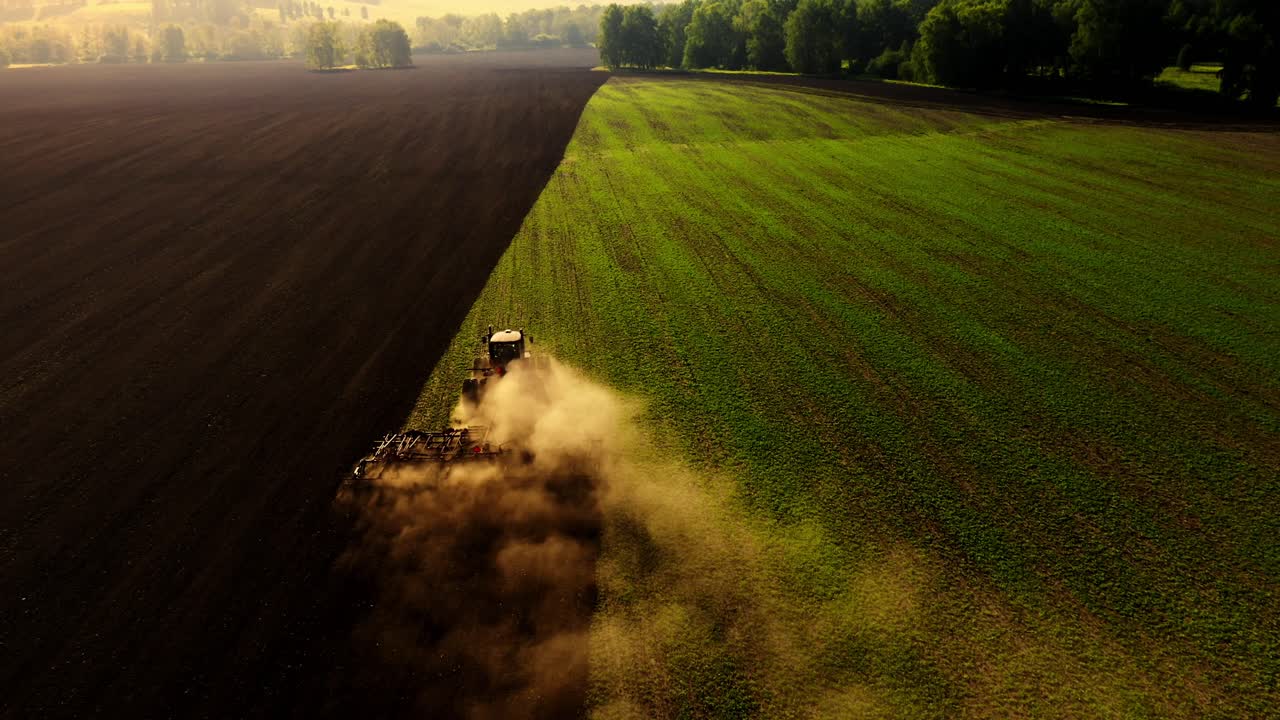 Un trattore che aria un campo