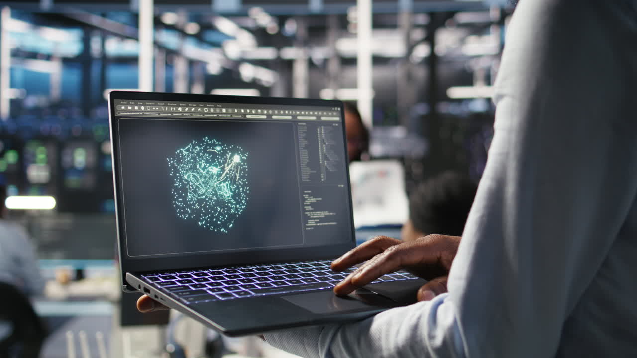 Close up of data center worker using laptop to interpret AI data analytics