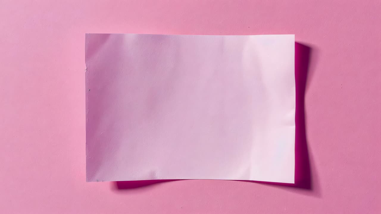 Moving light sweeping diagonal shadows across wrinkled pale sheet on pink backdrop, revealing marks