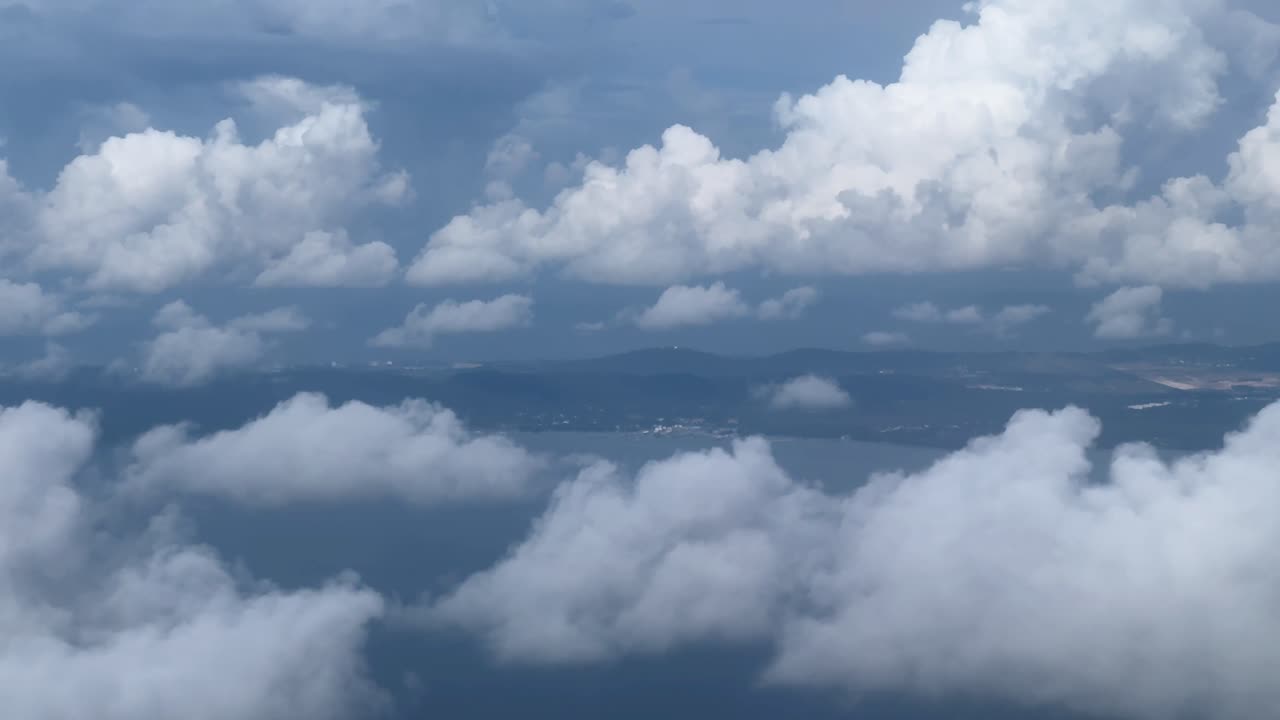 Clouds over mountains during daytime evoke a serene, peaceful mood
