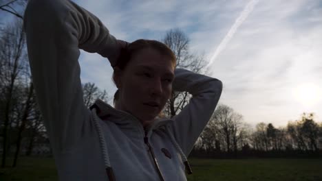 young attractive woman tying hair up before a run