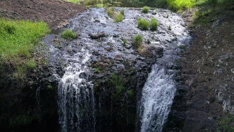 floating over the ledge of a waterfall