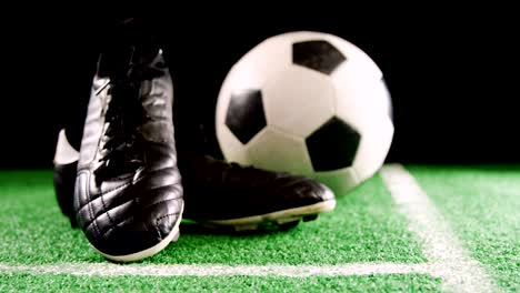 close-up of football and cleats on artificial grass 4k