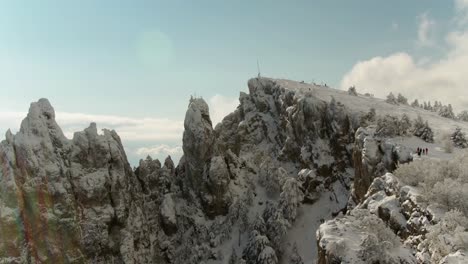 snowy mountain peak with hikers