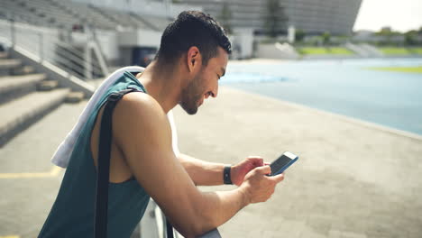 Young-athlete-using-phone-browsing-online