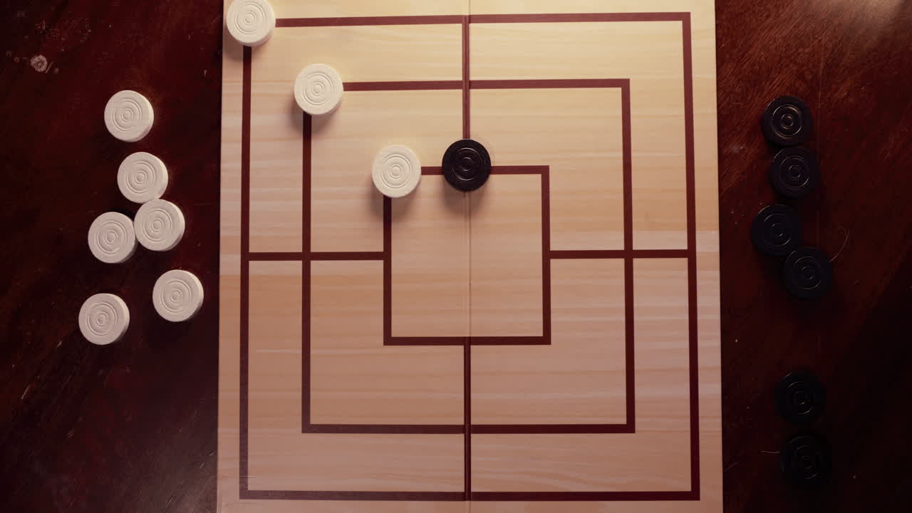 Two Hands Playing Nine Men's Morris Board Game on a Wooden Table