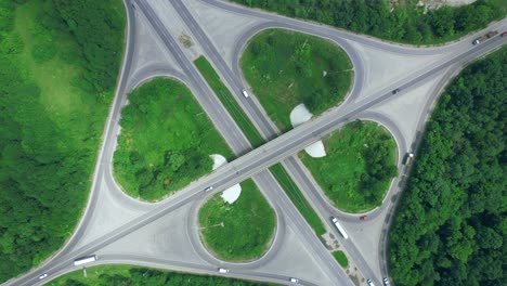 busy urban traffic. aerial top view traffic on circle road in city at day. 4k stock footage.