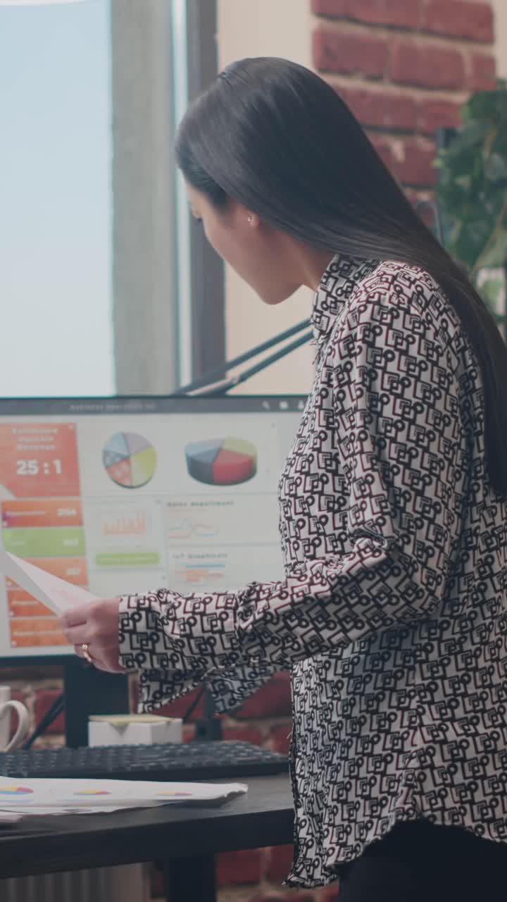 Asian Businesswoman Analyzing Data in Office