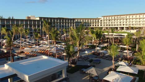 aerial over deluxe tropical resort hotel, bright sunny morning