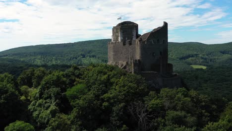 Drone-footage-about-Ruins-of-an-old-castle-from-the-middle-ages-at-Holloko,-Hungary-Drone-circles-right