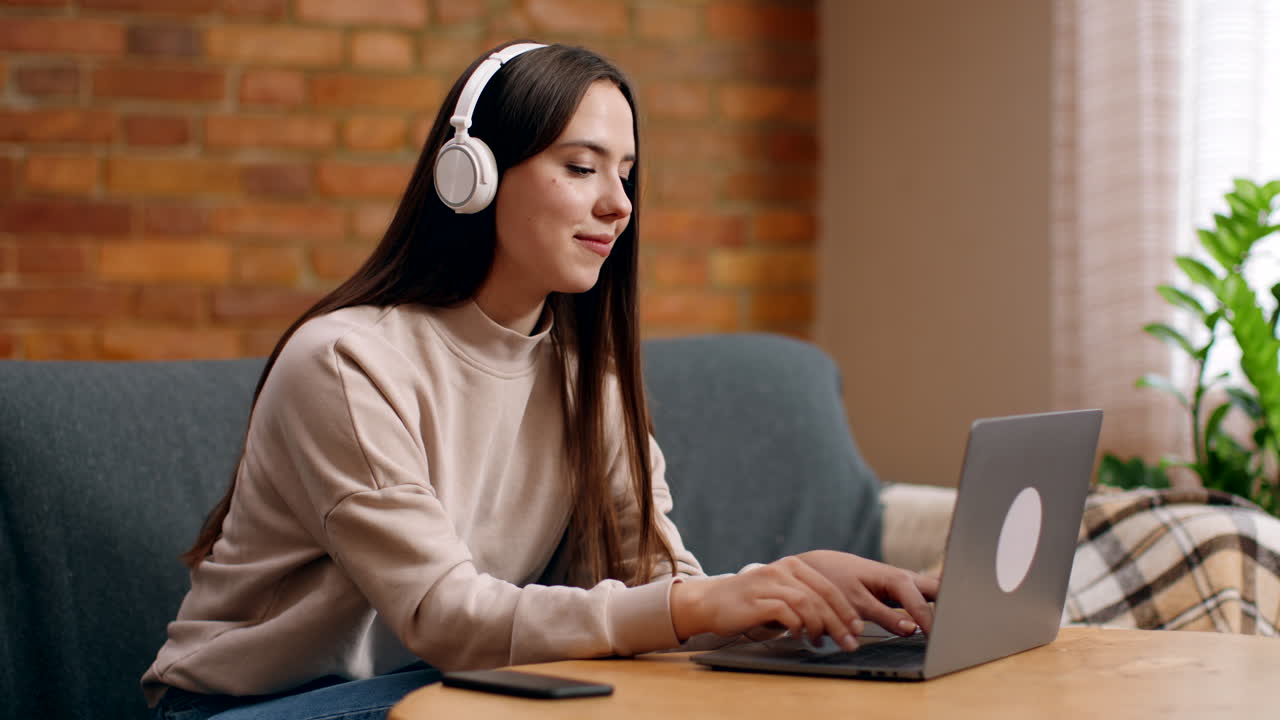 Young Woman Working on Laptop at Home