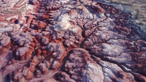 Textured-background-of-uneven-surface-of-sandstone-cliffs-in-sunlight