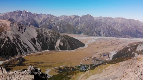 High-rise-aerial-of-Southern-Alps-valley-and-Mt-Cook-Village