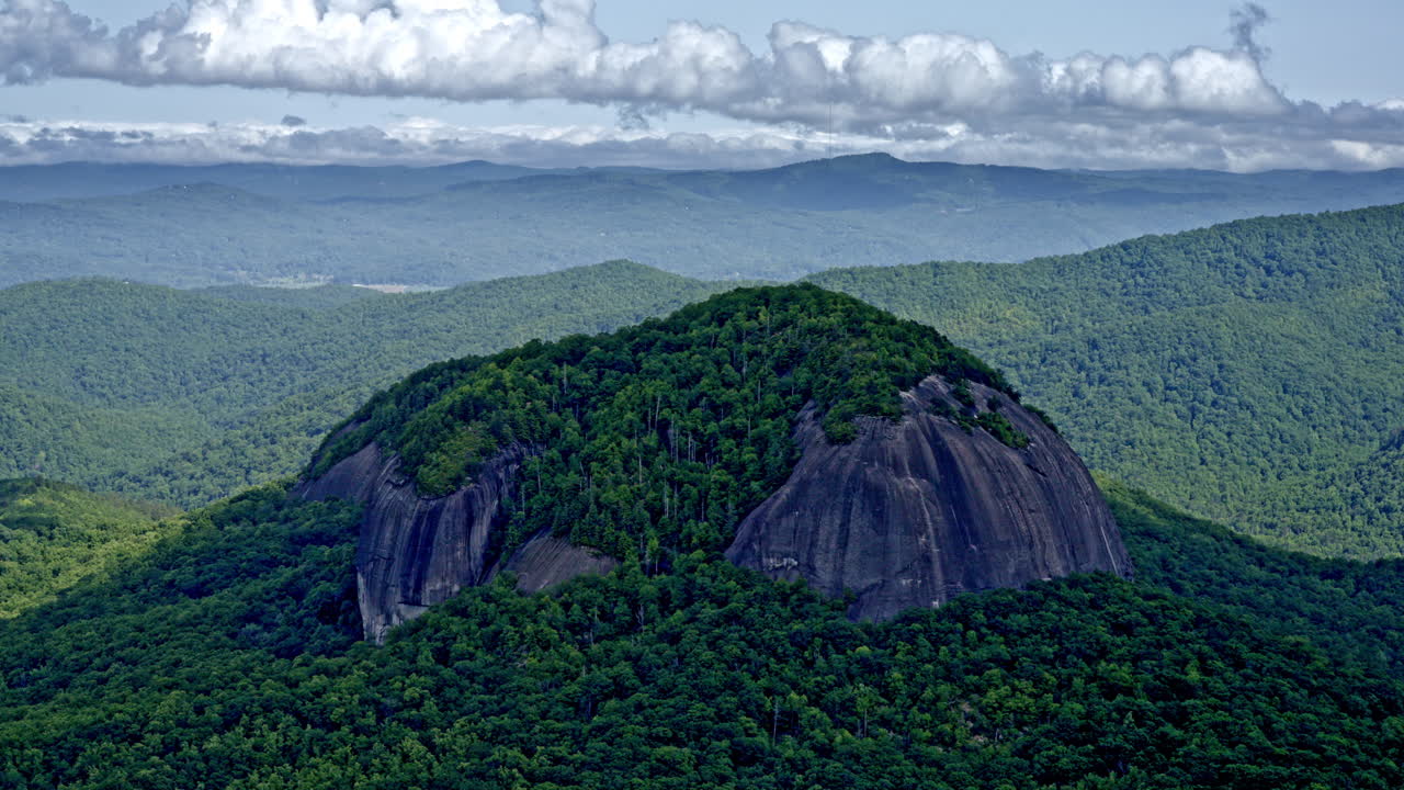 Drone shot of big lone mountain standing apart from the rest of the range