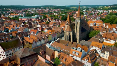 4k aerial drone video of the historic half-timbered homes around the st. johannis kirche church in downtown ansbach, germany