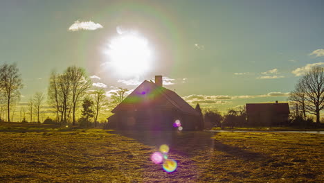 The-sun-sets-just-above-the-horizon-behind-a-country-home