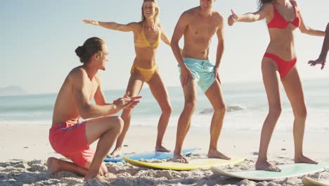 friends training surf styling on the sand