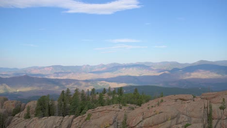 Rocky-Mountains-viewed-from-an-overlook-on-a-hazy-day,-timelapse