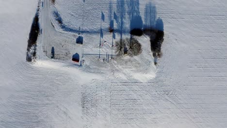 a view from above of a landscape covered with snow and a snowy hill in the background