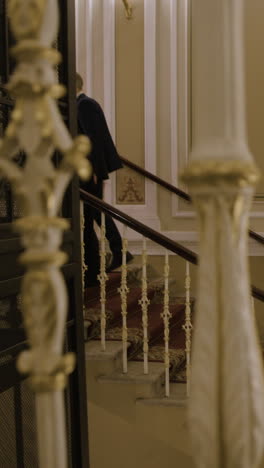 people walking upstairs in a grand hotel