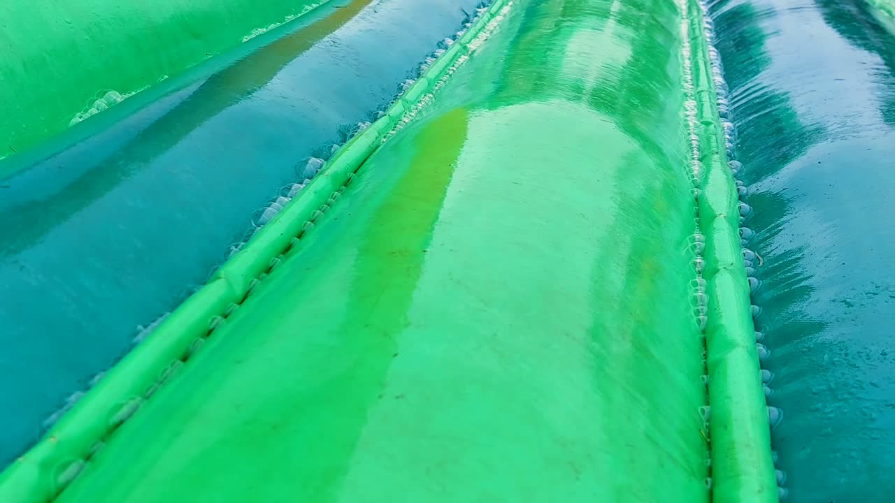 Bouncy house in the rain, bubbles appear on the seams