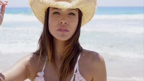 gorgeous young sunbather wears straw hat
