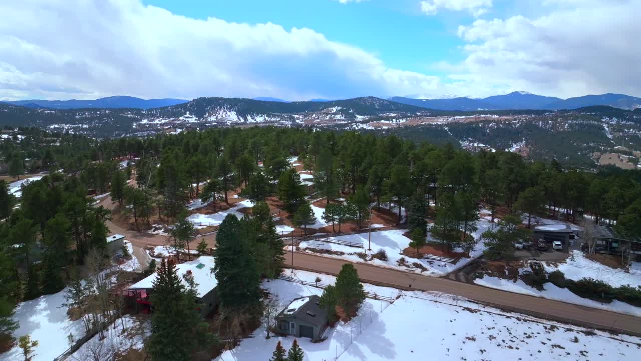 Lookout Mountain Buffalo Bills Grave Genesse Evergreen Golden Colorado aerial drone view winter sunny blue sky cloudy afternoon i70 highway Rocky Mountains neighborhood homes snowy forward motion