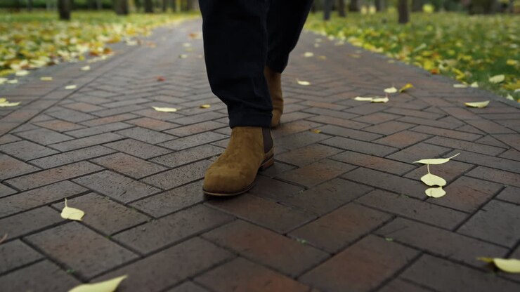 Man in boots walking through the park
