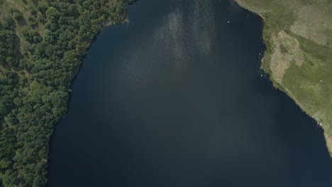 Wicklow, Ireland - A Stunning Lake, Lough Tay, Surrounded by Vibrant Greenery and Majestic Mountains - Aerial Topdown Shot