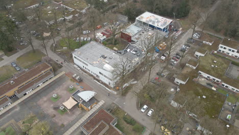 aerial of large building under construction in a small town