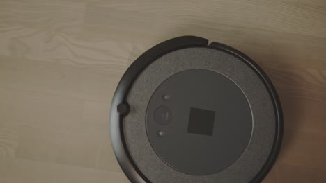 a robot vacuum carrying out its task - close up