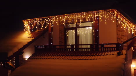 beautiful lighting home during christmas night, lit and decorated, aerial view