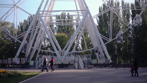 in the park, a large ferris wheel is spinning slowly. high-altitude view wheel