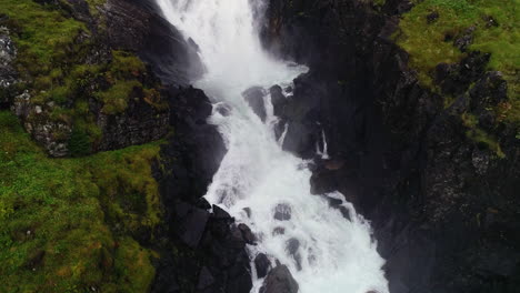 aerial forward dolly revealing large step down of låtefossen at dusk