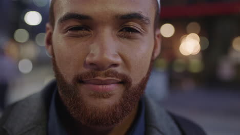 close up portrait of young pensive mixed race man turns head looking at camera confident serious wearing traditional muslim kufi hat