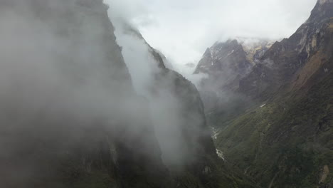 épica toma aérea de drones atravesando las nubes para revelar el lado brumoso de las montañas annapurna, nepal