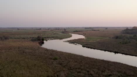 aerial view of natural wetland landscape of meandering cuando river at dusk, namibia, africa