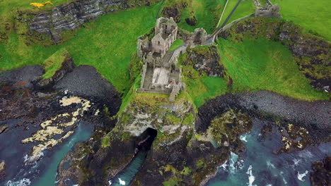 rotating drone shot of dunluce castle, now-ruined medieval castle in northern ireland