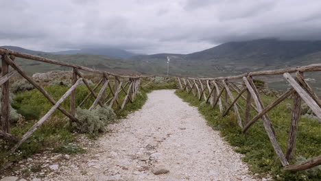 pathway through a rustic wooden fence in a scenic countryside