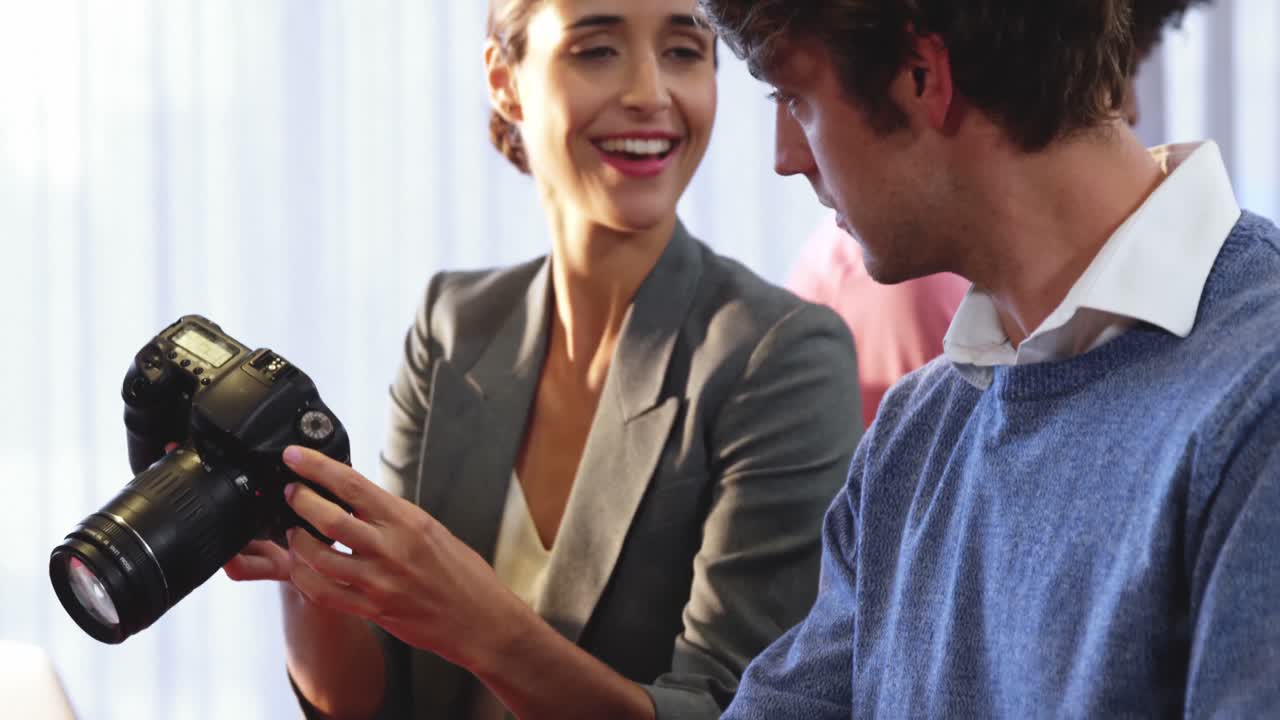 hombres de negocios mirando una cámara digital