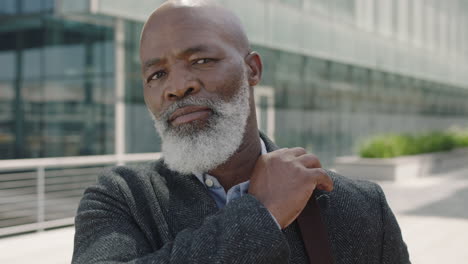 close up portrait of serious african american businessman looking confident at camera wearing suit