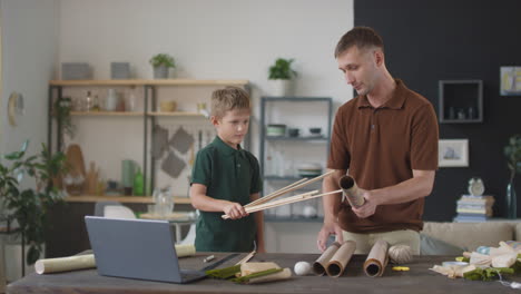 father and son crafting together