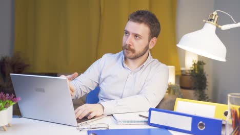 Home-office-worker-man-says-come-to-camera,-calling-you.