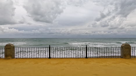 4k shot of the beach and sandy walkway at marbella, spain