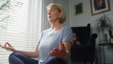 close up video of senior woman meditating at home