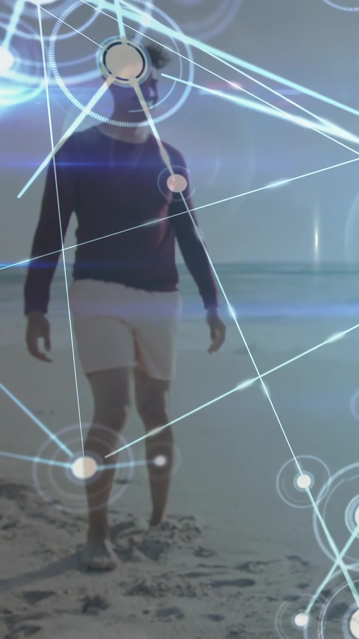 Video verticale: Scia luminosa che scintilla e nodi in espansione mentre un uomo cammina attraverso una rete, mostrando tecnologia.